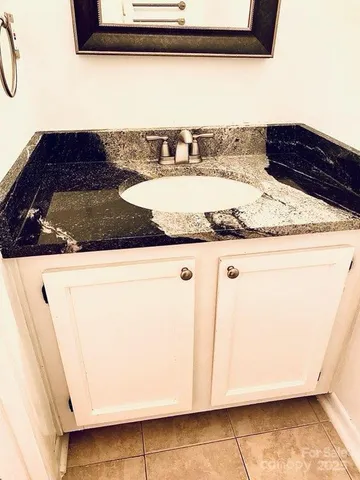 a view of a sink and dishwasher with wooden floor