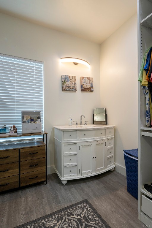 135 Wilbarger Bend Road Bastrop, TX 78602 - Photo 14 of 37 Bathroom with vanity, wood finished floors, and baseboards