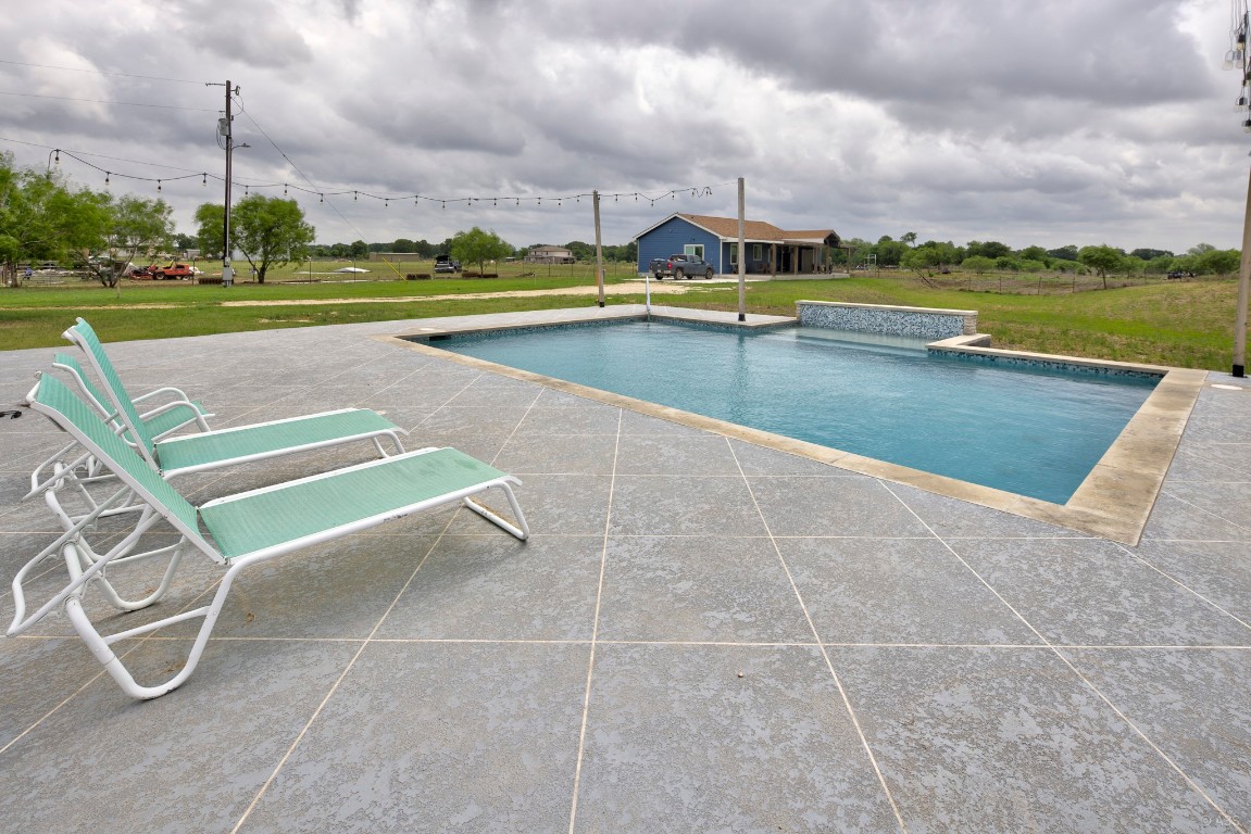 135 Wilbarger Bend Road Bastrop, TX 78602 - Photo 16 of 37 Outdoor pool with a lawn