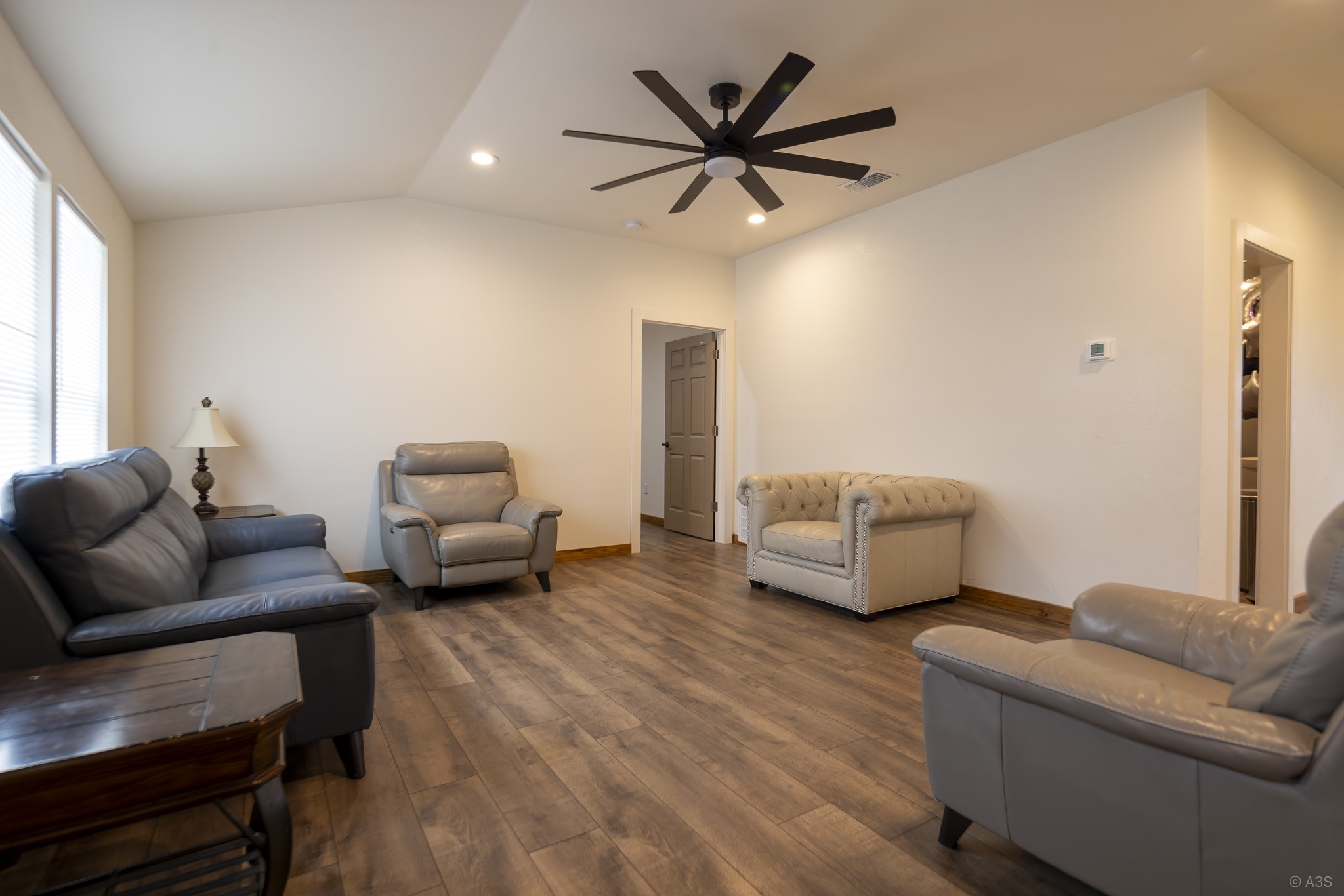135 Wilbarger Bend Road Bastrop, TX 78602 - Photo 20 of 39 a living room with furniture and a wooden floor