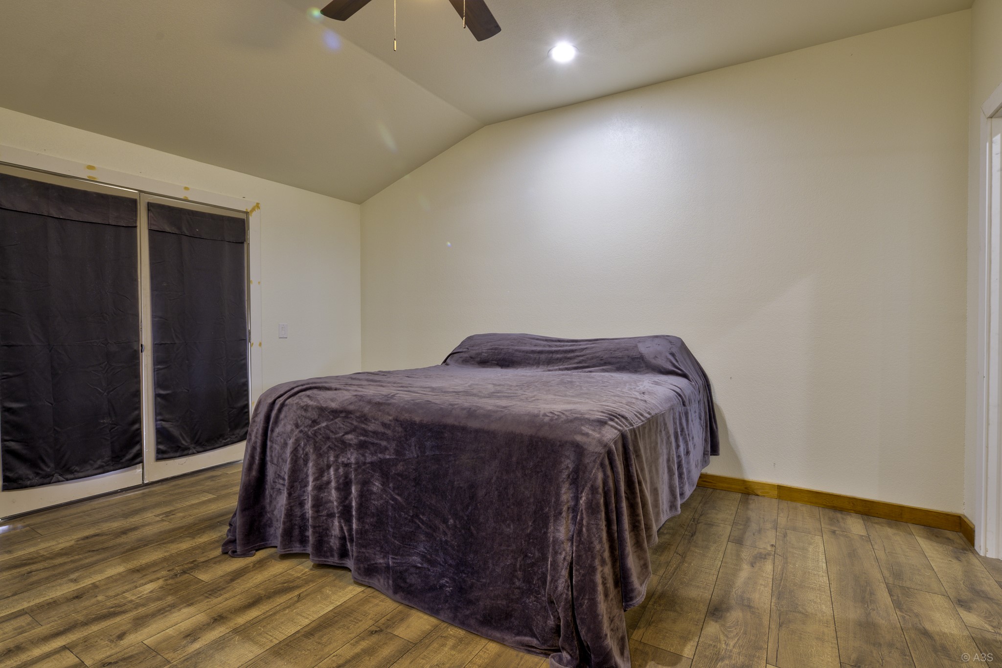 135 Wilbarger Bend Road Bastrop, TX 78602 - Photo 25 of 39 a bedroom with a bed and wooden floor