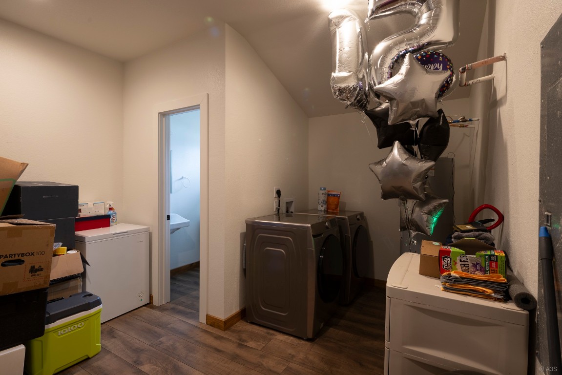 135 Wilbarger Bend Road Bastrop, TX 78602 - Photo 28 of 37 Laundry area with separate washer and dryer, laundry area, and dark wood-style floors
