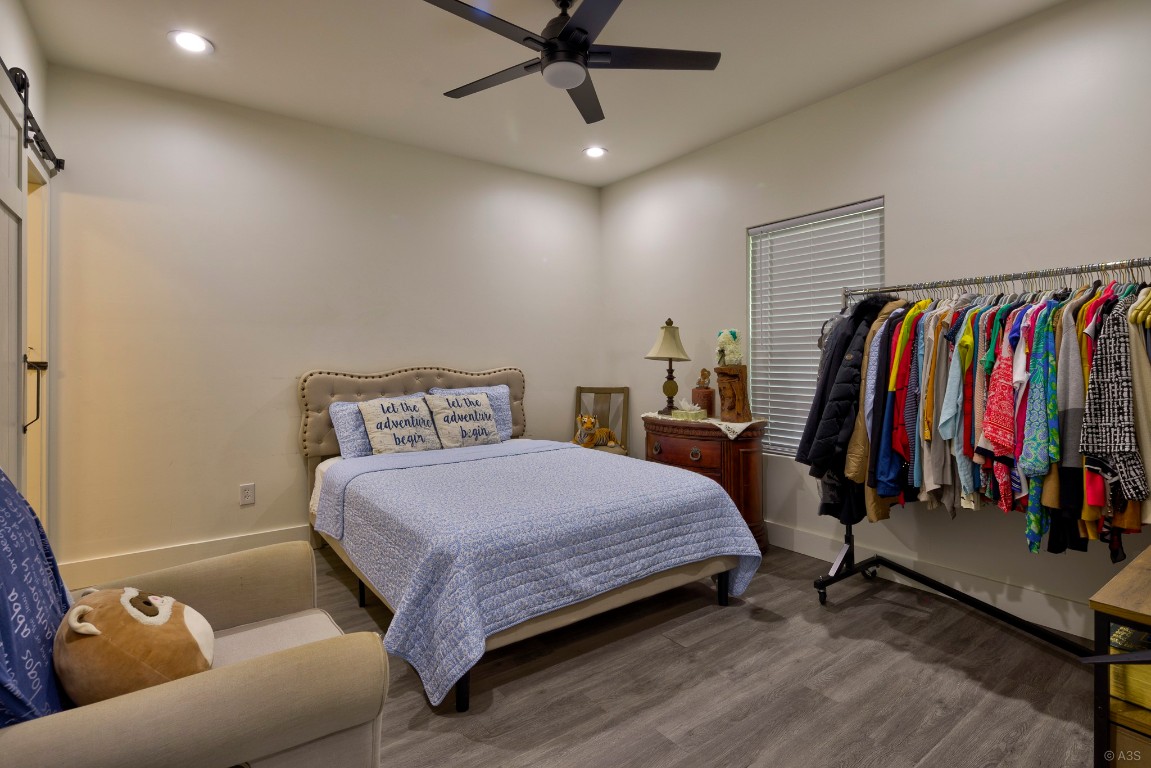 135 Wilbarger Bend Road Bastrop, TX 78602 - Photo 9 of 37 Bedroom featuring wood finished floors, baseboards, a ceiling fan, and recessed lighting