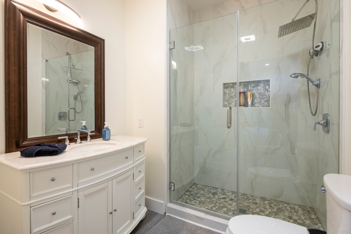 135 Wilbarger Bend Road Bastrop, TX 78602 - Photo 10 of 37 Bathroom with toilet, a marble finish shower, and vanity
