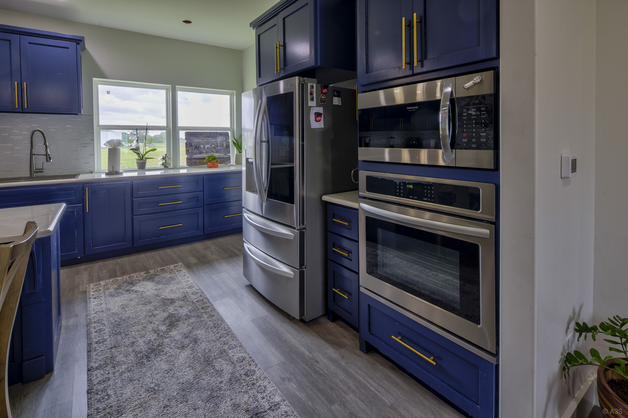 135 Wilbarger Bend Road Bastrop, TX 78602 - Photo 10 of 39 a kitchen with wooden cabinets and a stove top oven