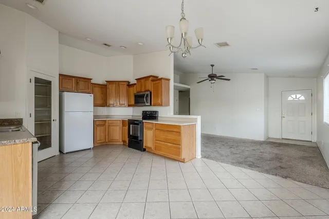 a kitchen with stainless steel appliances a refrigerator sink and cabinets
