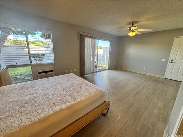 a spacious bedroom with a bed and a chandelier