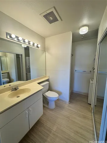 a bathroom with a double vanity sink toilet and shower