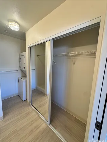 an empty room with wooden floor and entrance