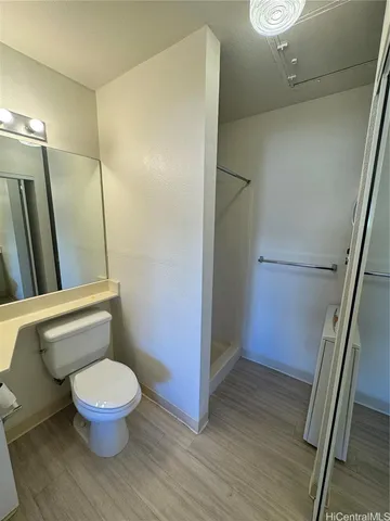 a bathroom with a toilet and a shower