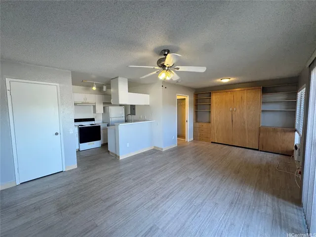 a view of an empty room with a kitchen