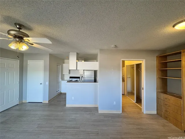 a view of a living room and kitchen with wooden floor