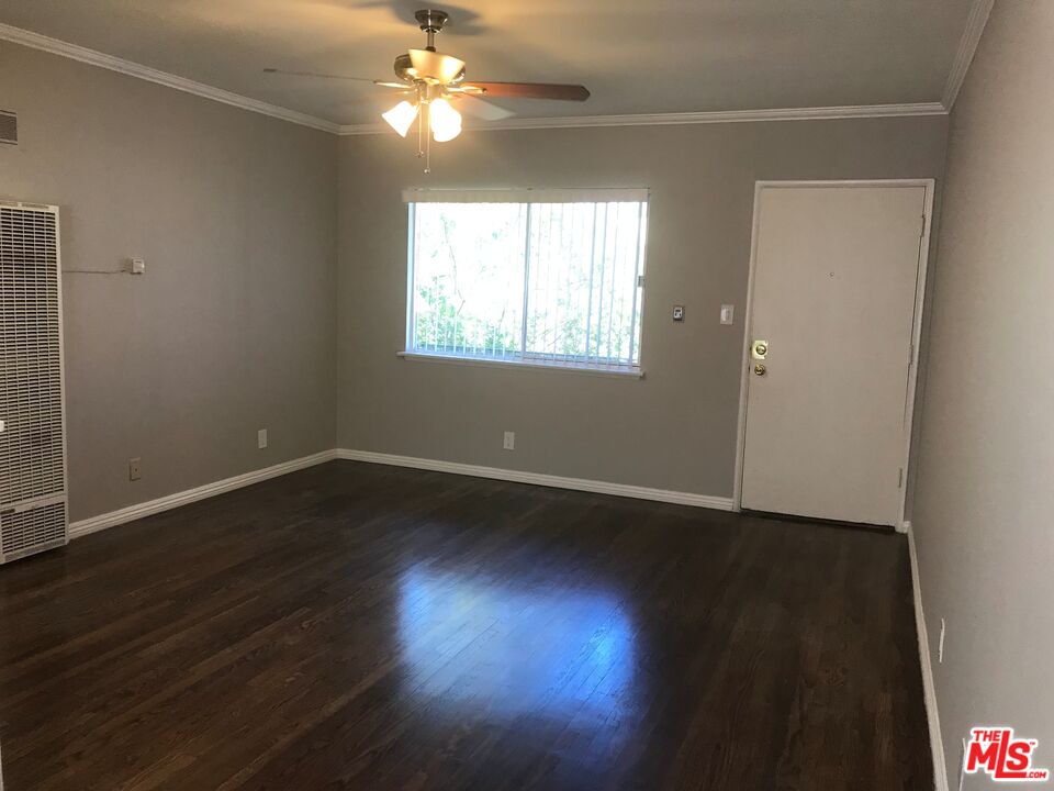 11510 Riverside Drive, Unit 2 North Hollywood, CA 91602 - Photo 4 of 8 an empty room with wooden floor and windows