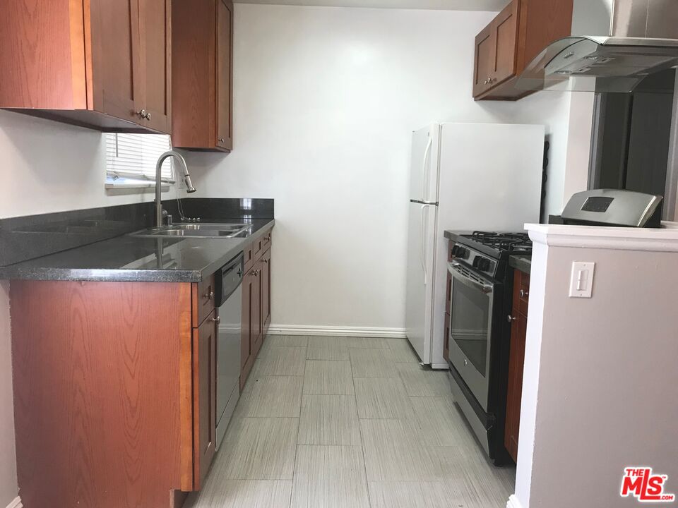 11510 Riverside Drive, Unit 2 North Hollywood, CA 91602 - Photo 5 of 8 a kitchen with stainless steel appliances granite countertop a refrigerator a sink a stove and dishwasher