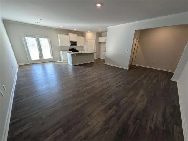 a kitchen with kitchen island white cabinets appliances and a sink