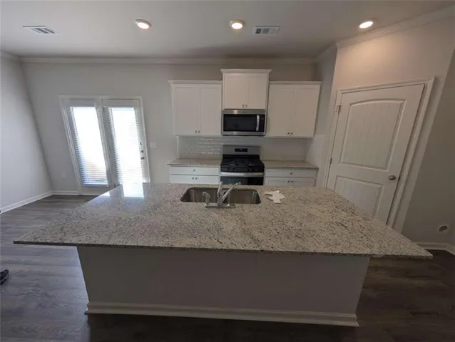 a view of kitchen island wooden floor and window