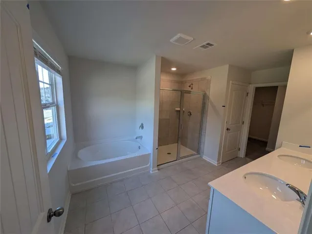 a bathroom with a double vanity sink and mirror