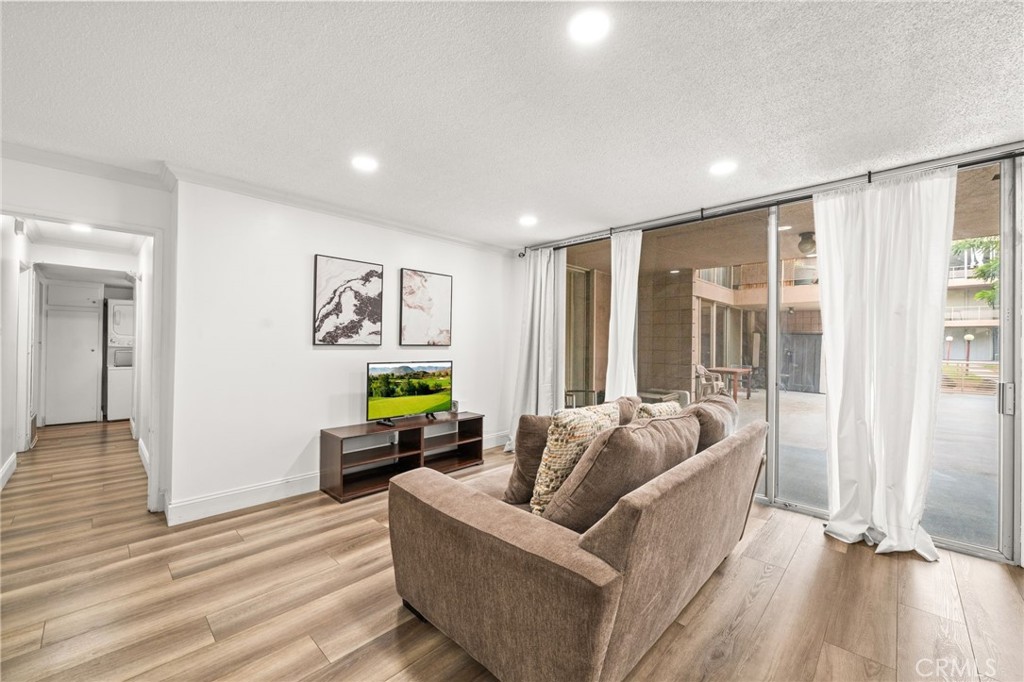 6979 Palm Court, Unit 104A Riverside, CA 92506 - Photo 11 of 53 a living room with furniture and a large window
