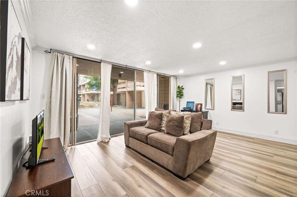 6979 Palm Court, Unit 104A Riverside, CA 92506 - Photo 12 of 53 a living room with furniture and a wooden floor