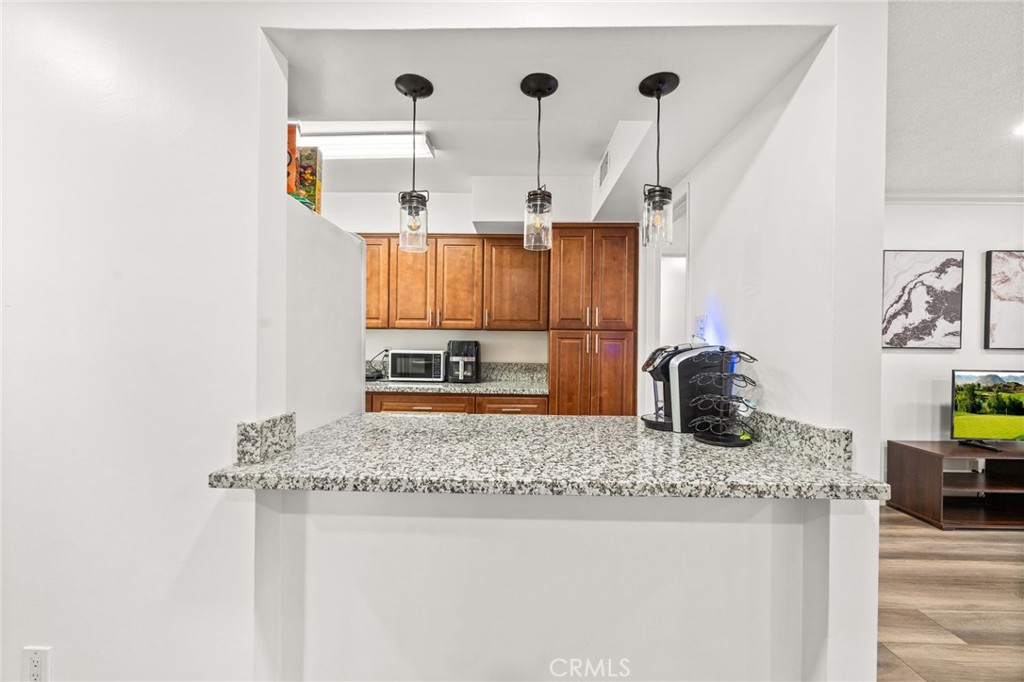 6979 Palm Court, Unit 104A Riverside, CA 92506 - Photo 15 of 53 a kitchen with stainless steel appliances granite countertop a sink a stove and a wooden cabinets