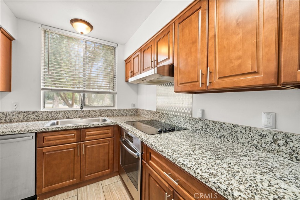 6979 Palm Court, Unit 104A Riverside, CA 92506 - Photo 17 of 53 a kitchen with stainless steel appliances granite countertop a sink and cabinets
