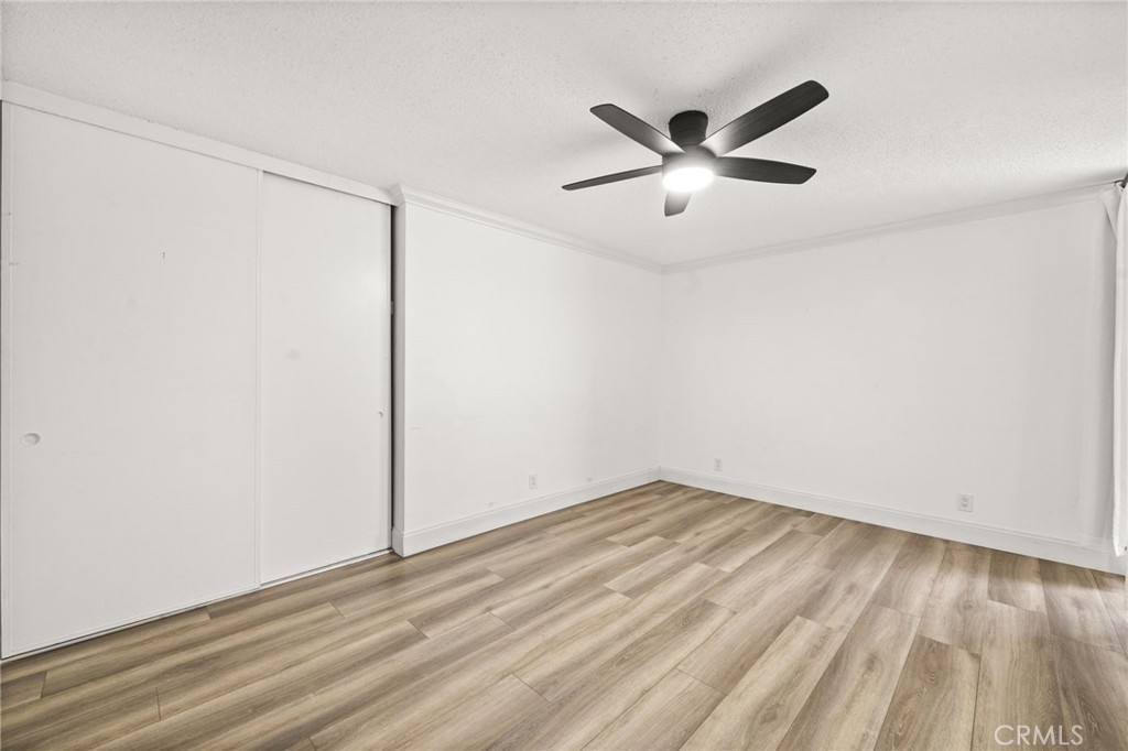 6979 Palm Court, Unit 104A Riverside, CA 92506 - Photo 24 of 53 a view of an empty room with wooden floor