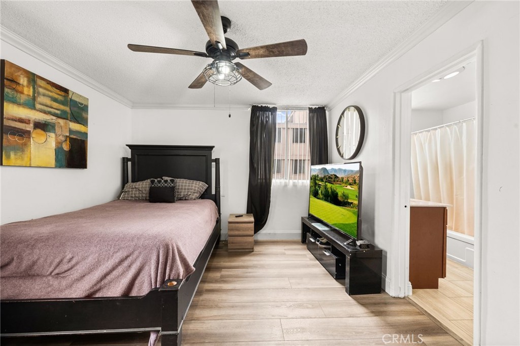 6979 Palm Court, Unit 104A Riverside, CA 92506 - Photo 26 of 53 a bedroom with a bed and a flat tv screen on dresser