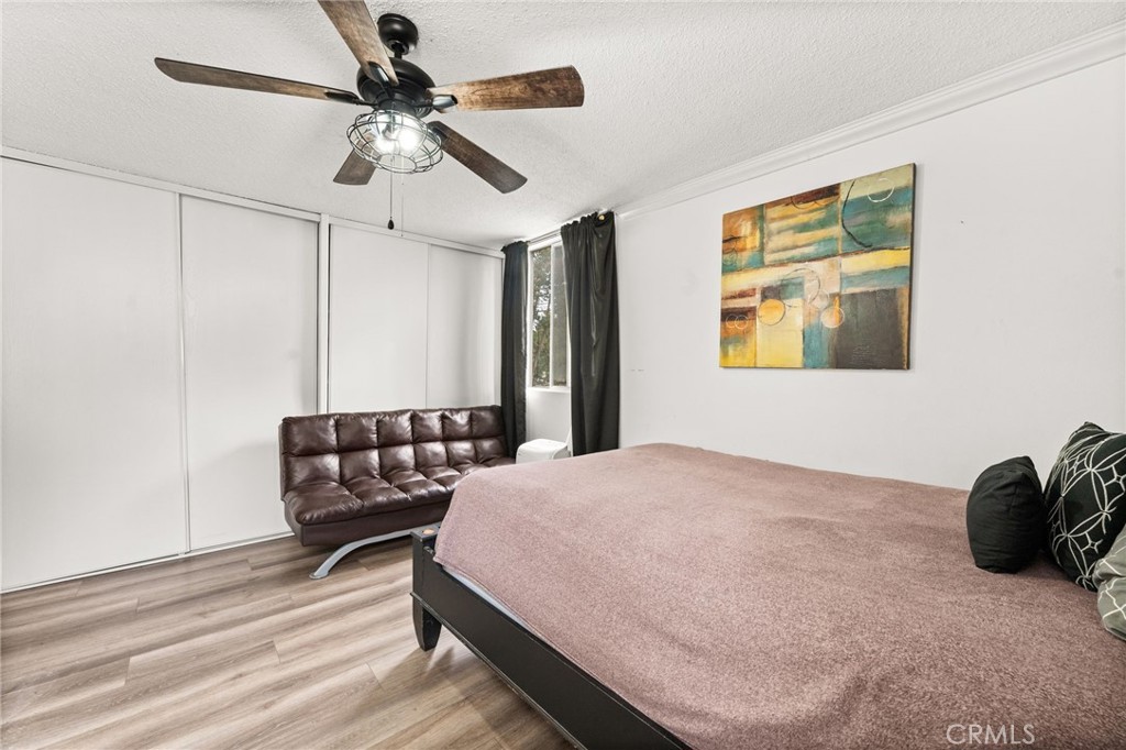 6979 Palm Court, Unit 104A Riverside, CA 92506 - Photo 27 of 53 a bedroom with a bed and wooden floor