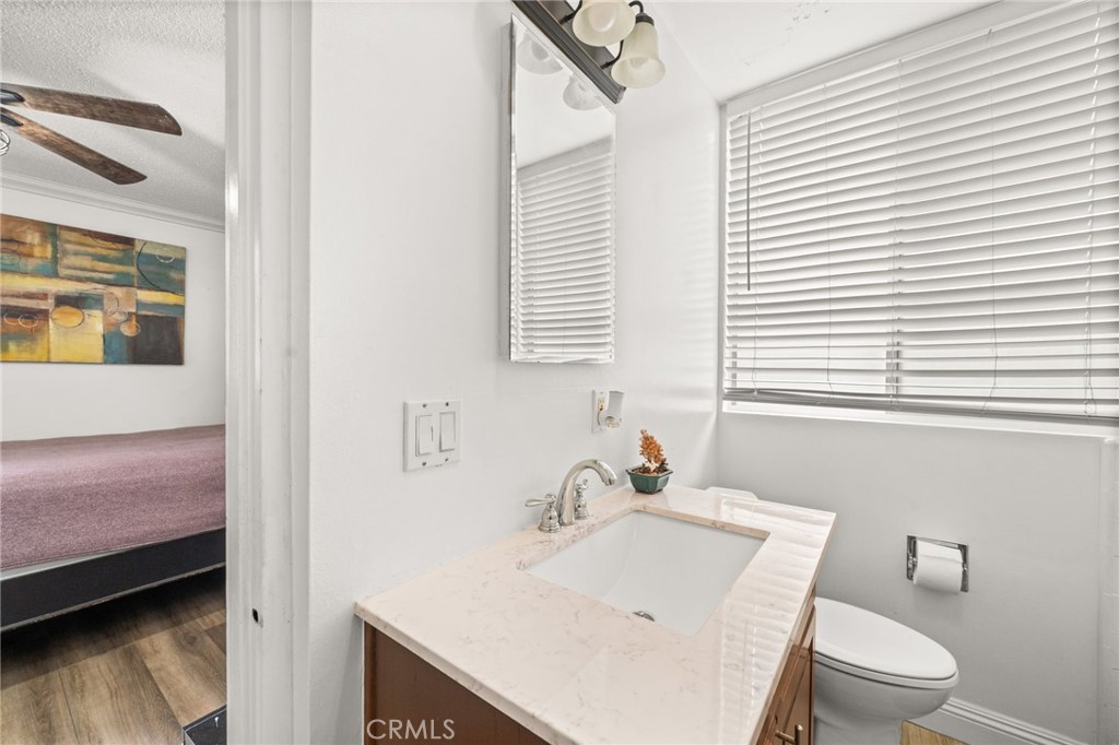 6979 Palm Court, Unit 104A Riverside, CA 92506 - Photo 28 of 53 a bathroom with a sink a toilet and vanity