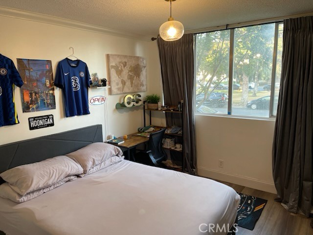 6979 Palm Court, Unit 104A Riverside, CA 92506 - Photo 30 of 53 a bedroom with a bed and a large window