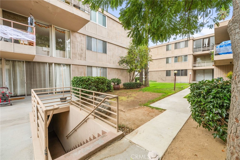 6979 Palm Court, Unit 104A Riverside, CA 92506 - Photo 39 of 53 a view of a white building with a yard