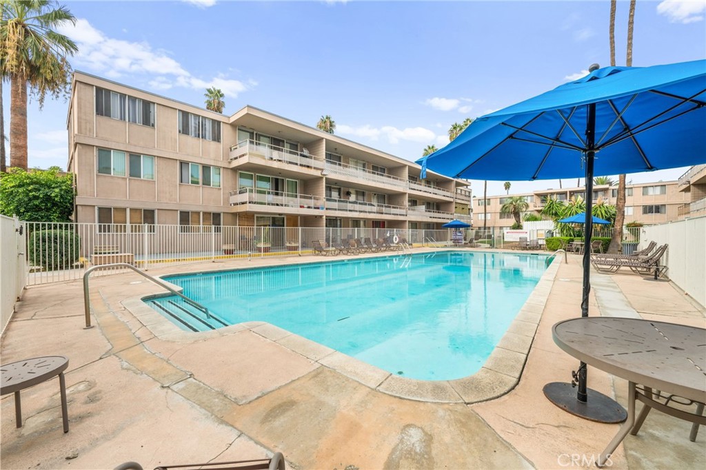 6979 Palm Court, Unit 104A Riverside, CA 92506 - Photo 41 of 53 a view of a swimming pool with a lounge chairs