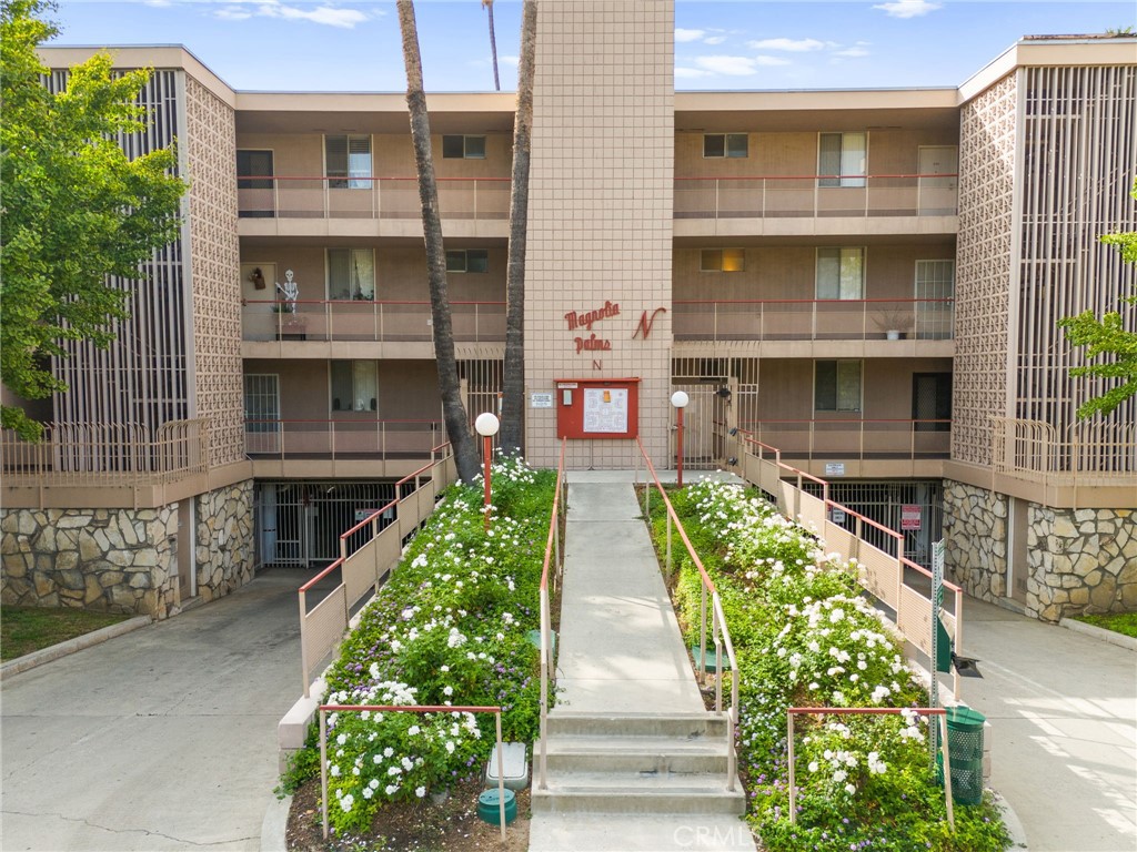 6979 Palm Court, Unit 104A Riverside, CA 92506 - Photo 5 of 53 a front view of a residential apartment building with a yard