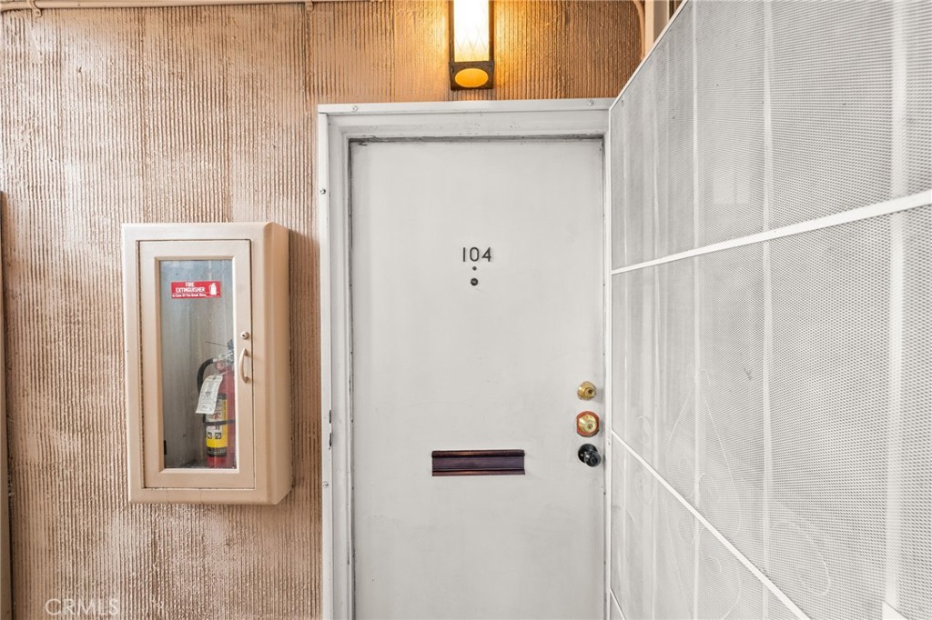 6979 Palm Court, Unit 104A Riverside, CA 92506 - Photo 8 of 53 a view of a hallway with wooden door