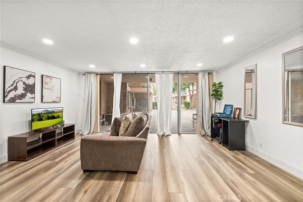 6979 Palm Court, Unit 104A Riverside, CA 92506 - Photo 10 of 53 a living room with furniture and a flat screen tv