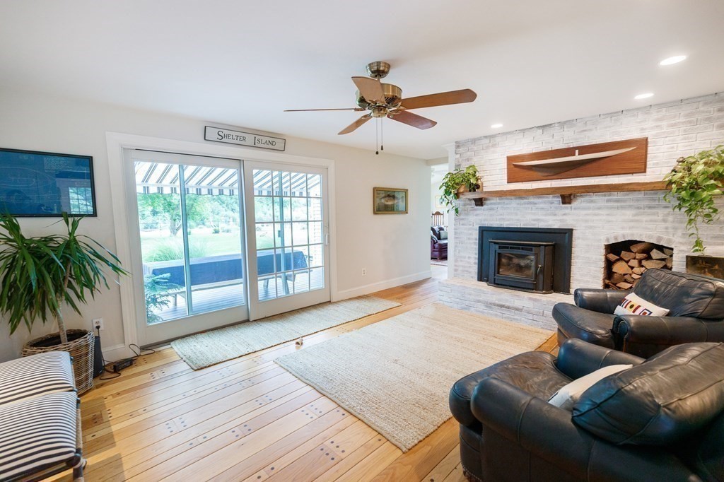 139 Fruit Street Hopkinton, MA 01748 - Photo 11 of 41 a living room with furniture large window and a fireplace