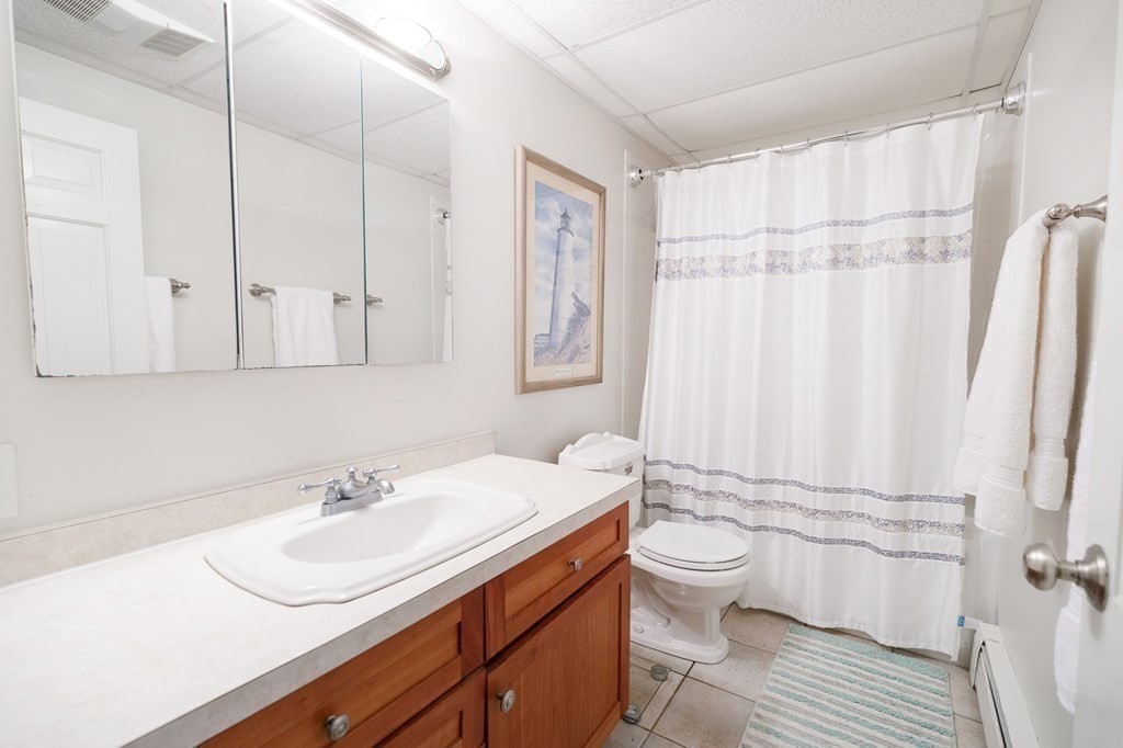 139 Fruit Street Hopkinton, MA 01748 - Photo 13 of 41 a bathroom with a sink toilet a mirror and shower