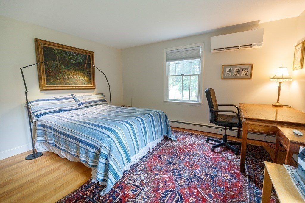 139 Fruit Street Hopkinton, MA 01748 - Photo 14 of 41 a bedroom with a bed a dresser and a window