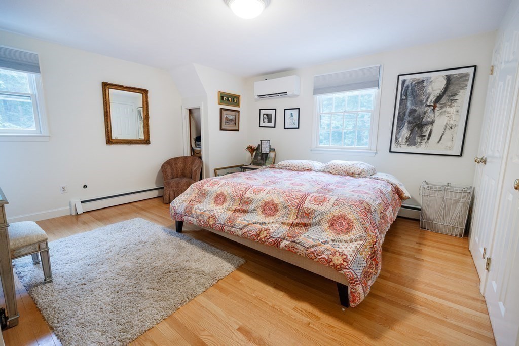 139 Fruit Street Hopkinton, MA 01748 - Photo 18 of 41 a bedroom with a bed painting on wall and a window