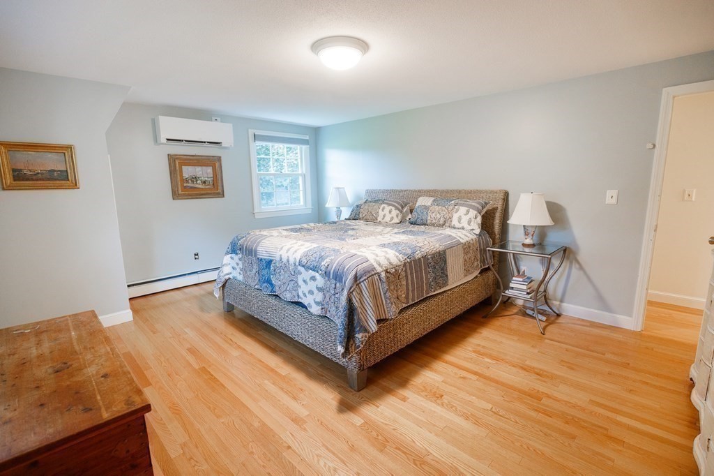 139 Fruit Street Hopkinton, MA 01748 - Photo 21 of 41 a bed sitting in a bedroom and table