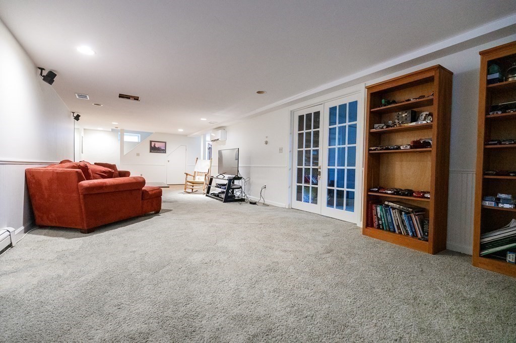 139 Fruit Street Hopkinton, MA 01748 - Photo 23 of 41 a living room with furniture and a flat screen tv