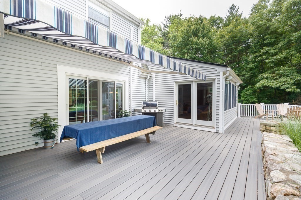 139 Fruit Street Hopkinton, MA 01748 - Photo 24 of 41 a blue bench sitting in front of a house