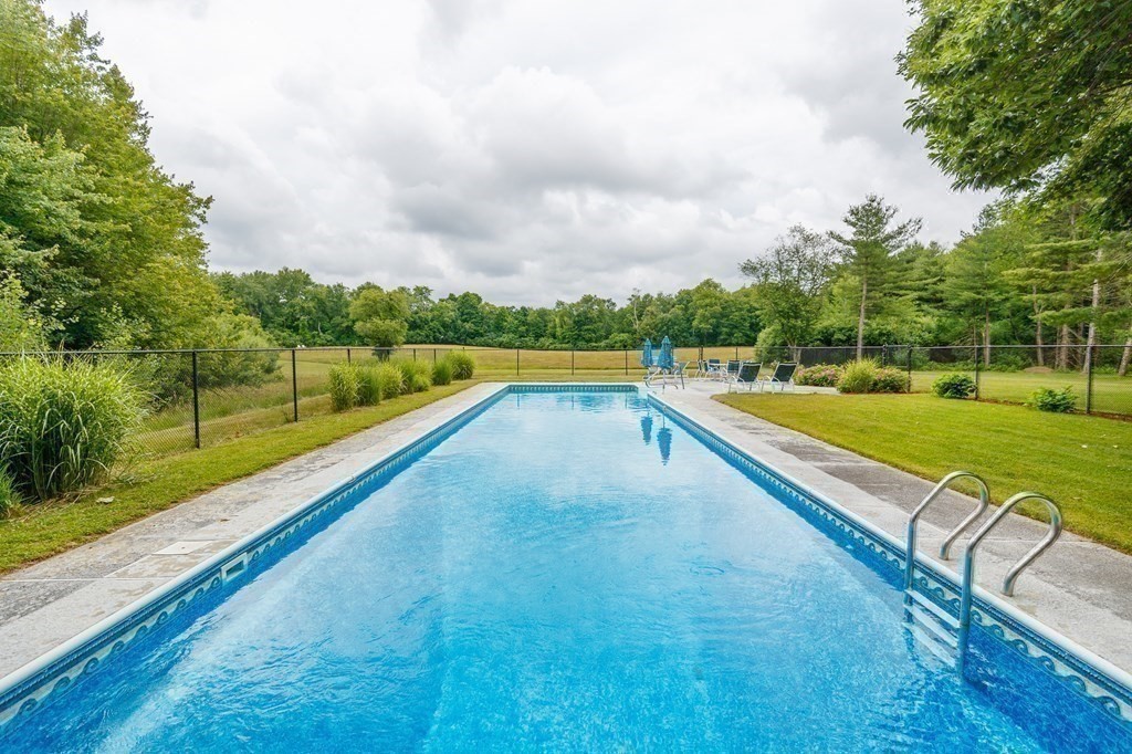 139 Fruit Street Hopkinton, MA 01748 - Photo 30 of 41 a view of swimming pool with a yard and large trees