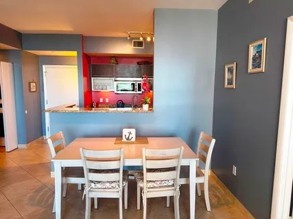 a dining room with furniture and window