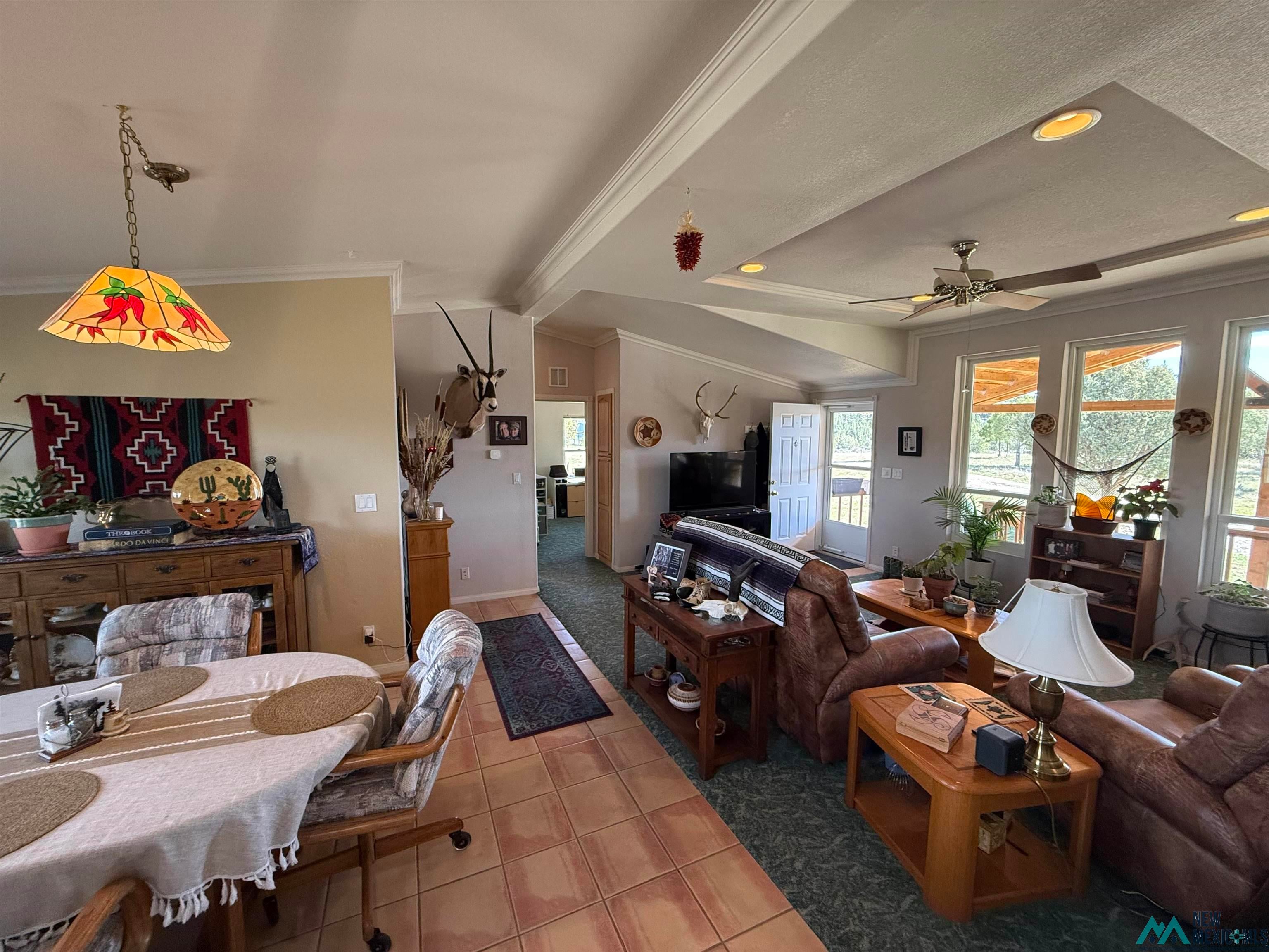 16 Overlook Road Los Ojos, NM 87551 - Photo 21 of 39 Tiled living area with vaulted ceiling, ornamental molding, ceiling fan, and recessed lighting
