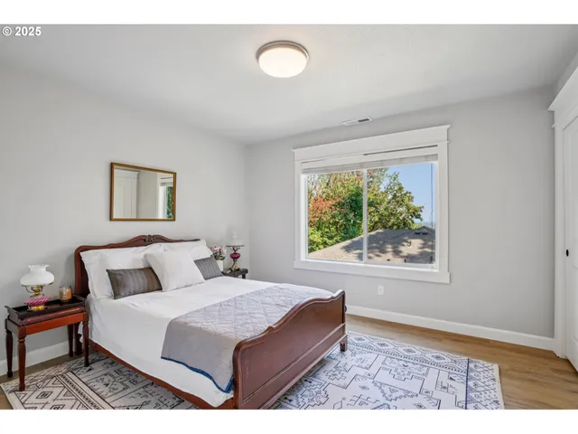 a bedroom with a bed and a painting on the wall