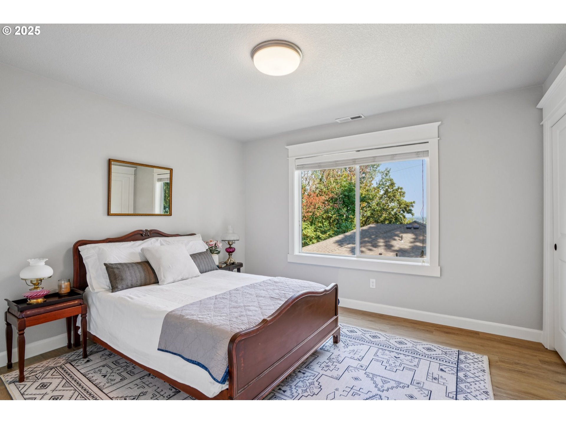 5862 Southwest Ralston Drive Portland, OR 97239 - Photo 26 of 41 a bedroom with a bed and a window