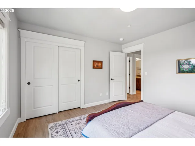 a bathroom with a granite countertop sink a toilet a mirror and shower