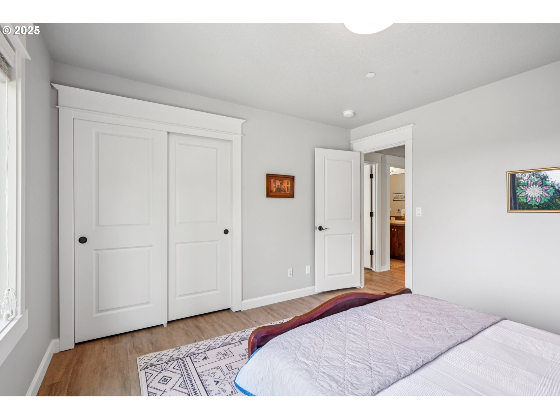 5862 Southwest Ralston Drive Portland, OR 97239 - Photo 27 of 41 a bedroom with a bed and a painting on the wall