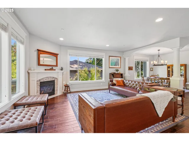 a dining room with furniture a chandelier and wooden floor